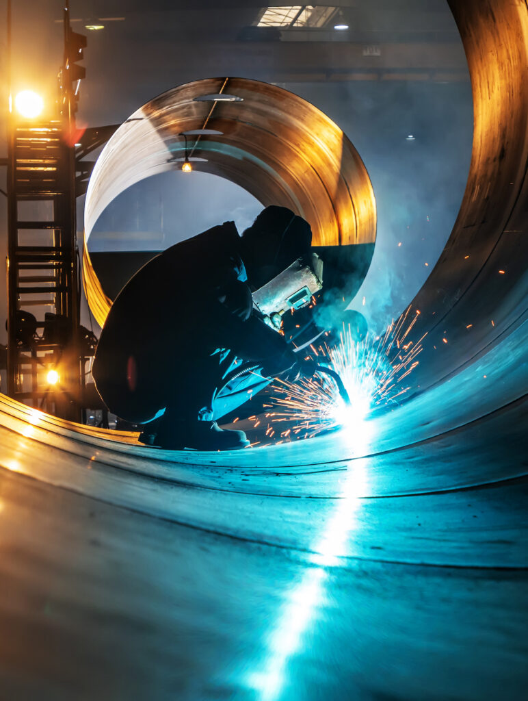 The welder is welding steel plates