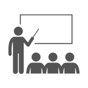 Untitled design (5) A person pointing to a white board in front of other people (icon)